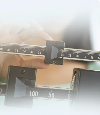 Woman weighing on scale after receiving weight loss services at Doctors Plus Urgent Care in Concord, NC.